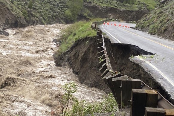 In this photo provided by the National Park Service, is high water in the Gardiner River along the North Entrance to Yellowstone National Park in Montana, that washed out part of a road on Monday, Jun ...