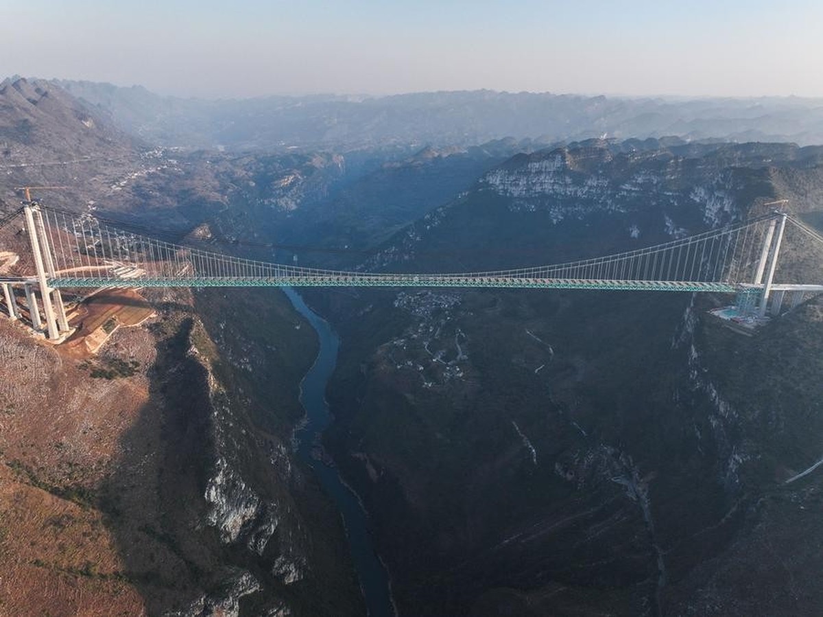 (250114) -- ZHENFENG, Jan. 14, 2025 (Xinhua) -- An aerial drone photo shows a view of the Huajiang grand canyon bridge in southwest China's Guizhou, Jan. 13, 2025. By far, 93 sections of the Huaj ...