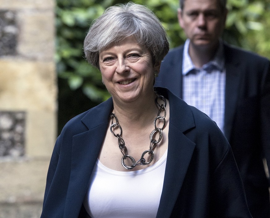 epa06022231 British Prime Minister Theresa May with her husband Philip (not pictured) attends St Andrews Church in Sonning, Berkshire, in her Maidenhead constituency, southern England 11 June 2017. B ...