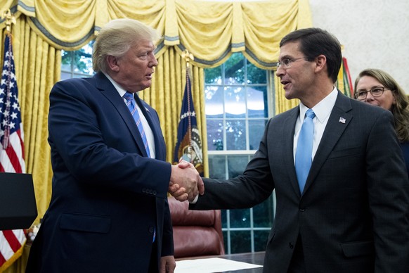 epa08810257 (FILE) - US President Donald J. Trump attends the ceremony of Mark Esper (R) being sworn-in as US Secretary of Defense, in the Oval Office of the White House in Washington, DC, USA, 23 Jul ...