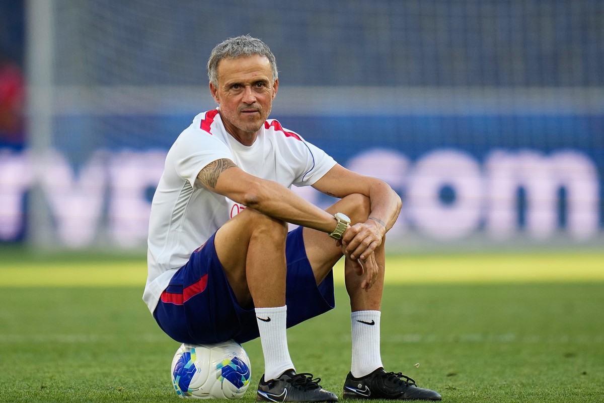 PSG's head coach Luis Enrique sits on a ball during a training session ahead of the UEFA Super Cup soccer match against Aston Villa in Salzburg, Austria, Tuesday, Aug. 11, 2026. (AP Photo/Darko B ...
