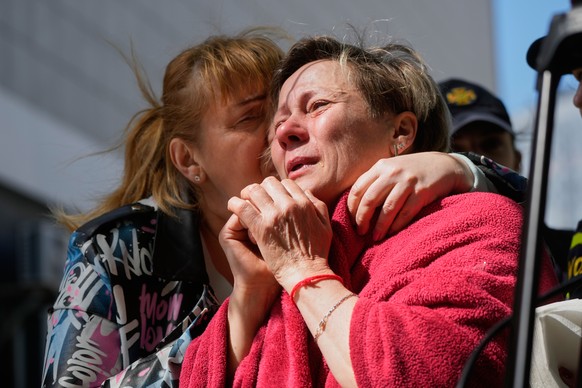 A neighbour hugs a crying woman at a site of a Russian missile attack on a residential building in Kyiv, Ukraine, Thursday, May 14, 2026. (AP Photo/Efrem Lukatsky)
APTOPIX Russia Ukraine War