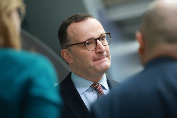epa12806341 Christian Democratic Union (CDU) faction chairman in the German parliament Bundestag, Jens Spahn, gestures as he talks to journalists upon leaving the CDU headquarters prior to a press con ...