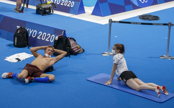 epa09357992 Swimmer Jeremy Desplanches (L) and diver Michelle Heimberger of Switzerland during a training session prior to the start of the Swimming events of the Tokyo 2020 Olympic Games at the Tokyo ...