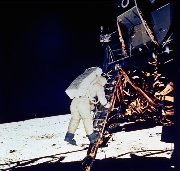 Astronaut Edwin &quot;Buzz&quot; E. Aldrin, Jr., lunar module pilot, descends steps of Lunar Module ladder as he prepares to walk on the moon, July 20, 1969. He had just egressed the Lunar Module. Thi ...