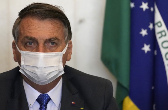 Brazil&#039;s President Jair Bolsonaro attends a meeting with Chamber of Deputies President Arthur Lyra to present a proposal for social programs at the Chamber of Deputies headquarters in Brasilia, B ...