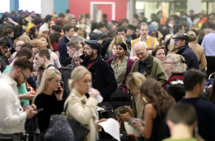 Passengers at Gatwick airport waiting for their flights following the delays and cancellations brought on by drone sightings near the airfield, in London, Friday Dec. 21, 2018. New drone sightings Fri ...