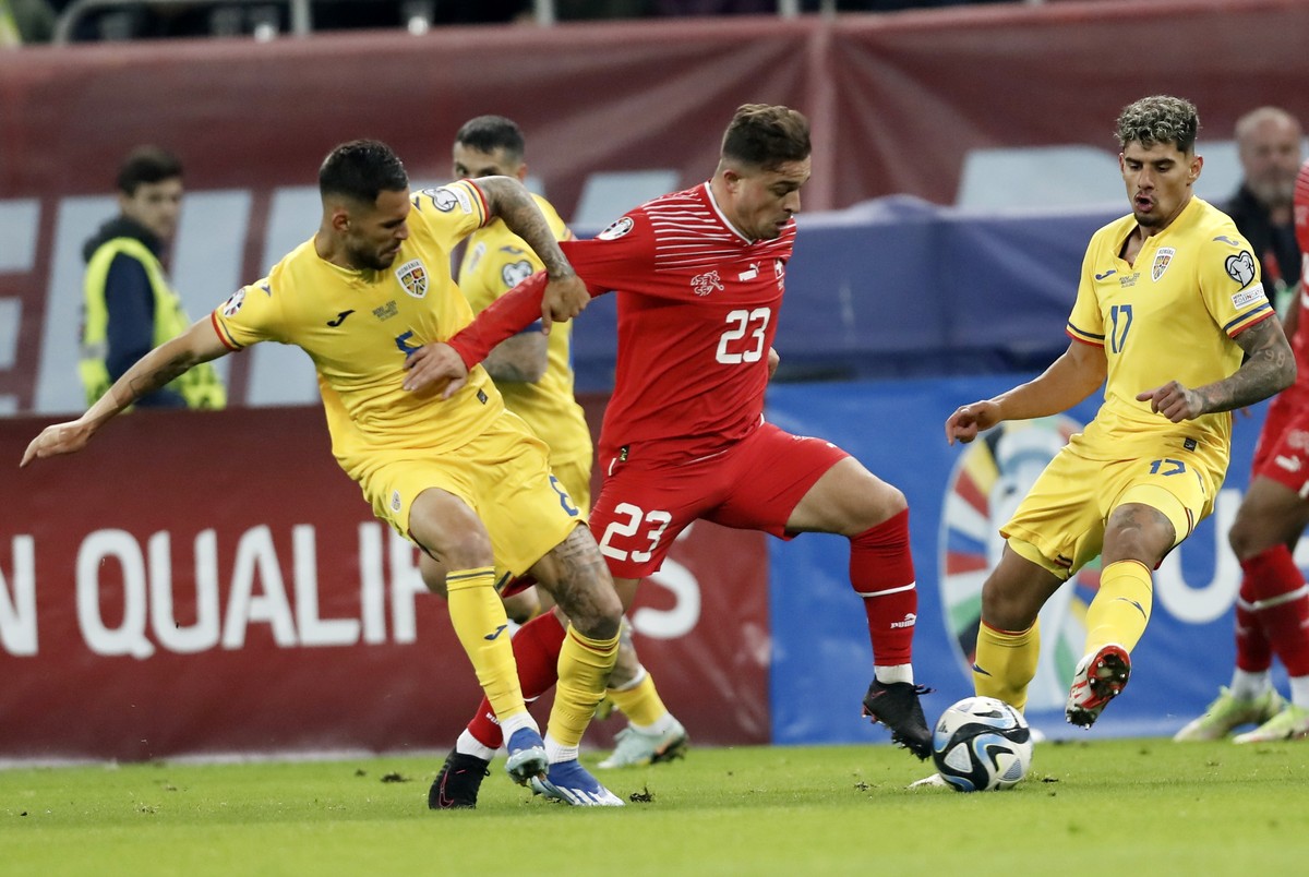 epa10988307 Romania's Vladimir Screciu (L) and Romania's Adrian Rus (R) in action against Switzerland's Xherdan Shaqiri (C) during the UEFA EURO 2024 Group I qualification match between ...