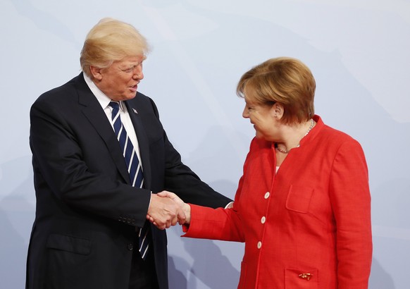 epa06072080 German Chancellor Angela Merkel (R) officially welcomes US President Donald J. Trump (L) to the opening day of the G20 summit in Hamburg, Germany, 07 July 2017. The G20 Summit (or G-20 or Group of Twenty) is an international forum for governments from 20 major economies. The summit is taking place in Hamburg 07 to 08 July 2017.  EPA/FRIEDEMANN VOGEL/POOL