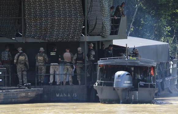 Federal police officers gather on an Army floating base during the search for Indigenous expert Bruno Pereira and freelance British journalist Dom Phillips in Atalaia do Norte, Amazonas state, Brazil, ...