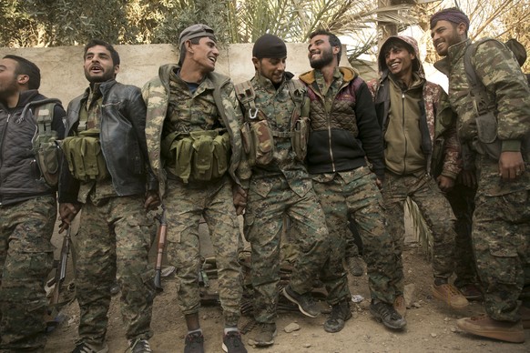 U.S.-backed Syrian Democratic Forces (SDF) fighters celebrate their territorial gains over Islamic State militants in Baghouz, Syria, move to a camp Tuesday, March 19, 2019. On Tuesday, a spokesman fo ...