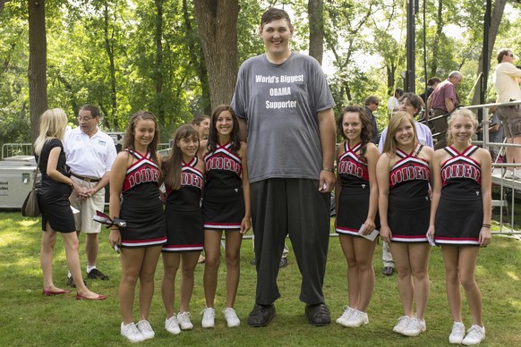 FILE- In this Aug. 15, 2011 photo, Seven-foot, eight-inch tall, Igor Vovkovinskiy, the self proclaimed biggest supporter of President Barack Obama, takes a photo with cheerleaders from the Cannon Fall ...