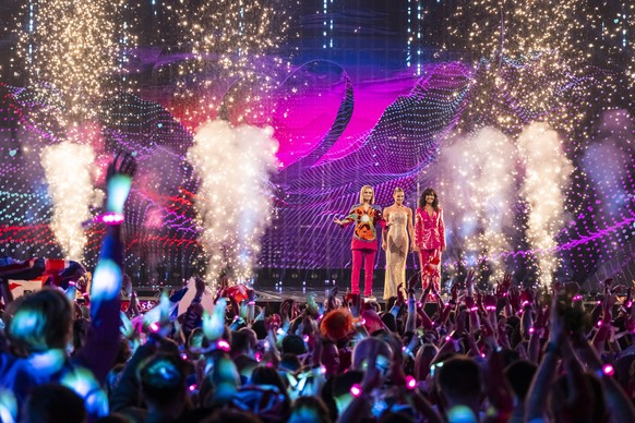 epa12110731 The hosts Hazel Brugger, Michelle Hunziker and Sandra Studer perform during the grand final of the 69th Eurovision Song Contest (ESC) in Basel, Switzerland, 17 May 2025. EPA/GEORGIOS KEFAL ...