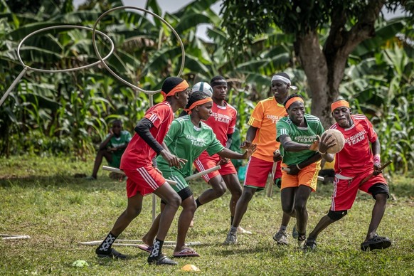 Chasers and beaters with sticks between their legs fight for the ball during a game of Quidditch, also known as Quadball, a sport inspired by the fictional game in the Harry Potter books, in the villa ...