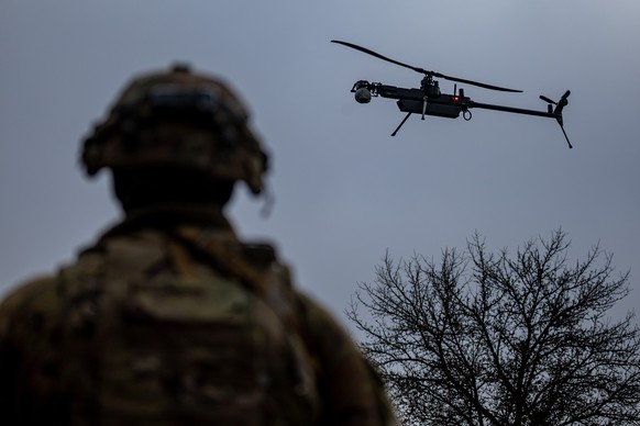 epa11873252 A US army soldier of the 3rd Brigade, 10th Mountain Division follows a Ghost-X drone during the Combined Resolve 25-1 military exercise in Hohenfels, Germany, 03 February 2025. The Combine ...
