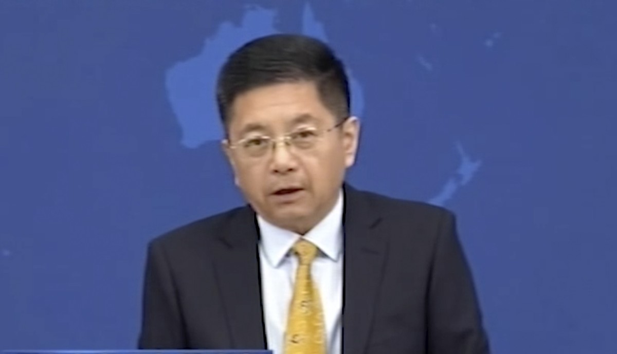 In this image taken from Oct. 13, 2021 video run by China's CCTV, Ma Xiaoguang, spokesperson of Taiwan Affair Office of the State Council, speaks during a press conference and the headline " ...