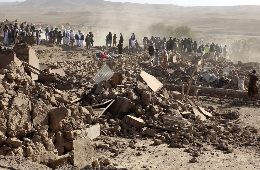 Afghan men search for victims after an earthquake in Zenda Jan district in Herat province, of western Afghanistan, Sunday, Oct. 8, 2023. Powerful earthquakes killed at least 2,000 people in western Af ...
