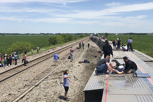In this photo provided by Dax McDonald, an Amtrak passenger train lies on its side after derailing near Mendon, Mo., on Monday, June 27, 2022. The Southwest Chief, traveling from Los Angeles to Chicag ...