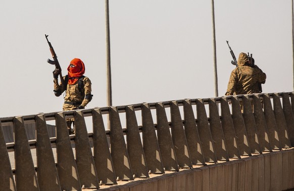 A mutinous soldier fires into the air at the Bobo interchange, near the Lamizana camp in Burkina Faso&#039;s capital Ouagadougou Sunday Jan. 23, 2022. Witnesses are reporting heavy gunfire at a milita ...