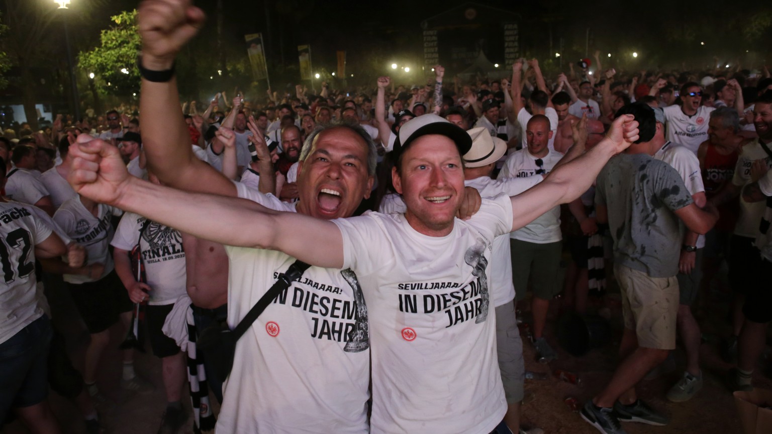 Eintracht Frankfurt supporters celebrate after their team equalised while watching the Europa League final on a screen between Eintracht Frankfurt and Glasgow Rangers in Seville, Spain, Wednesday, May ...