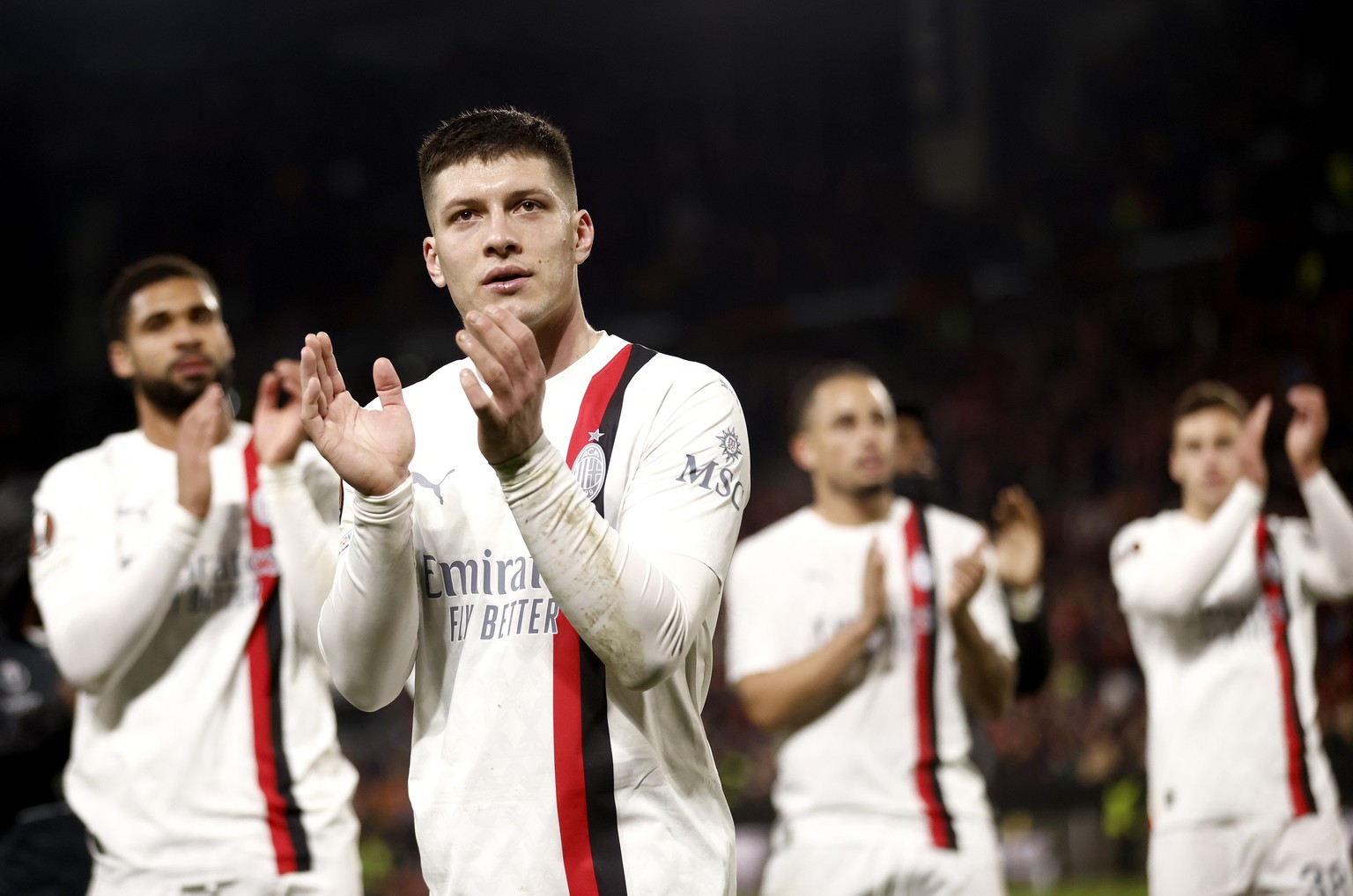 epa11173303 Luka Jovic of Milan and teammates applaud their fans at the end of the UEFA Europa League knock- out round play-offs, 2nd leg soccer match between Stade Rennes and AC Milan in Rennes, Fran ...