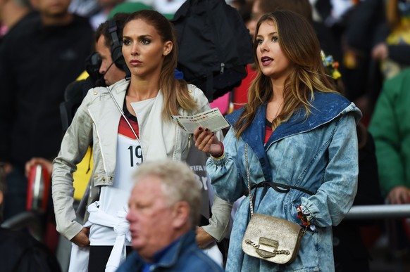 PORTO ALEGRE, BRAZIL - JUNE 30: Ann-Kathrin Broemmel (L), girlfriend of Mario Goetze of Germany, and Montana Yorke, girlfriend of Andre Schuerrle of Germany, look on from the crowd during the 2014 FIF ...