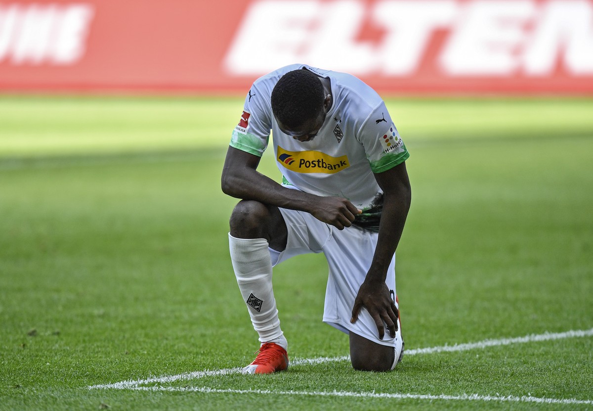 Moenchengladbach's Marcus Thuram taking the knee after scoring his side's second goal during the German Bundesliga soccer match between Borussia Moenchengladbach and Union Berlin in Moenchen ...