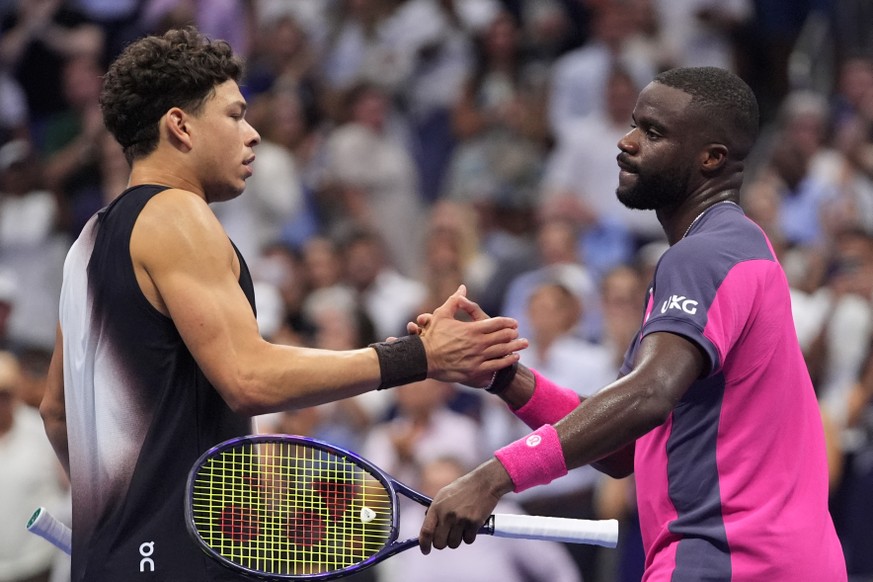 Frances Tiafoe, of the United States, right, greets Ben Shelton, of the United States, after Shelton won their match during the men's singles semifinals of the U.S. Open tennis championships Frid ...