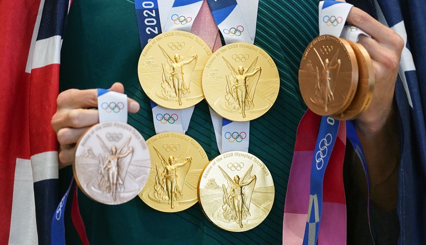 epa09386941 Four-time Tokyo 2020 Gold medalist Emma McKeon shows off her medal haul of 4 Gold and 3 Bronze medals during a press conference at the Main Press Centre during the Tokyo Olympic Games, in  ...