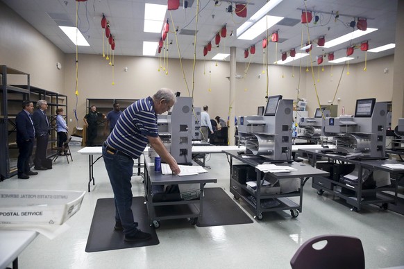 Elections staff prepare for a recount at the Broward County Supervisor of Elections office during on Sunday, Nov. 11, 2018, in Lauderhill, Fla. (AP Photo/Brynn Anderson)
