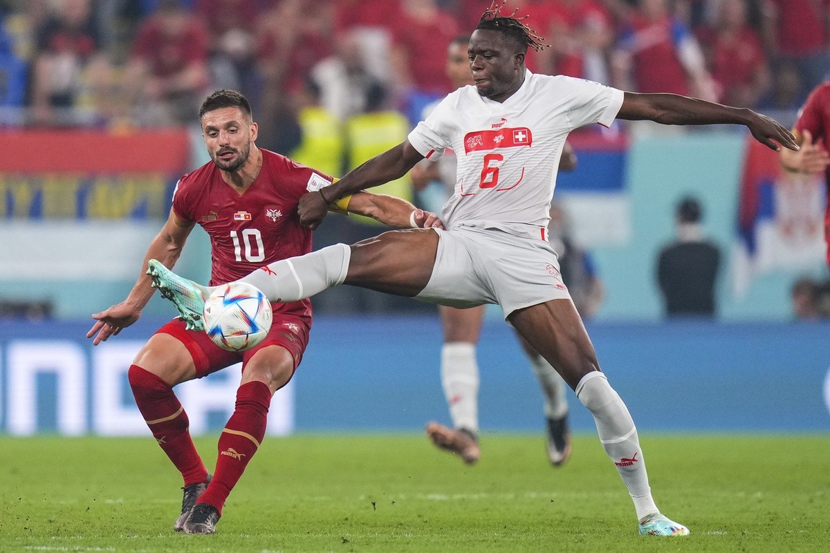 Switzerland's Denis Zakaria, right, vies for the ball with Serbia's Dusan Tadic during the World Cup group G soccer match between Serbia and Switzerland, at the Stadium 974 in Doha, Qatar, F ...