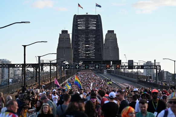 epa10503761 People march across the Sydney Harbour Bridge as part of the 2023 WorldPride festival in Sydney, Australia, 05 March 2023. EPA/STEVEN SAPHORE AUSTRALIA AND NEW ZEALAND OUT