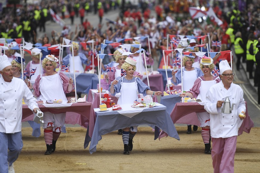 epa09997506 Performers in afternoon tea themed costumes parade during the Platinum Pageant celebrating the Platinum Jubilee of Britain&#039;s Queen Elizabeth II in London, Britain, 05 June 2022. The P ...