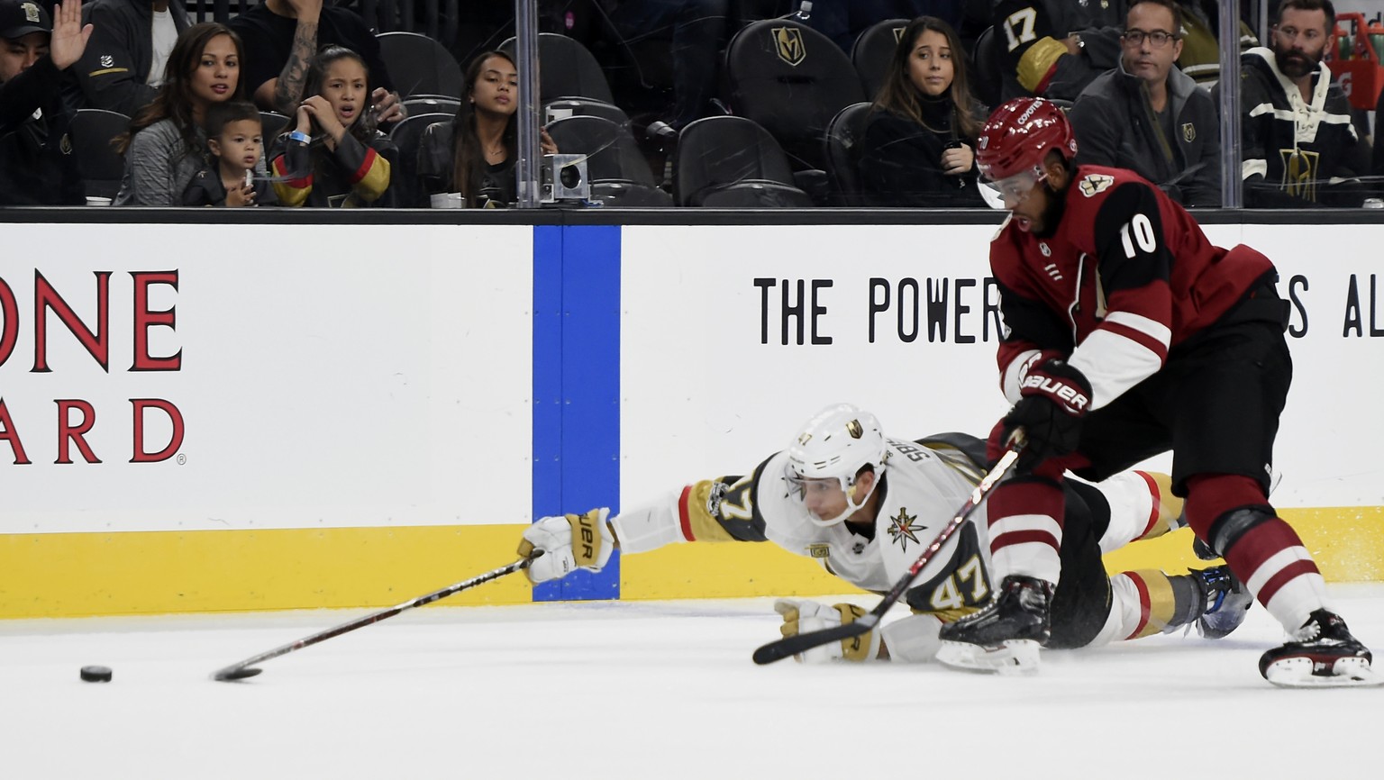 Vegas Golden Knights defenseman Luca Sbisa (47) dives for the puck with pressure from Arizona Coyotes left wing Anthony Duclair during the first period of an NHL hockey game, Sunday, Dec. 3, 2017, in  ...