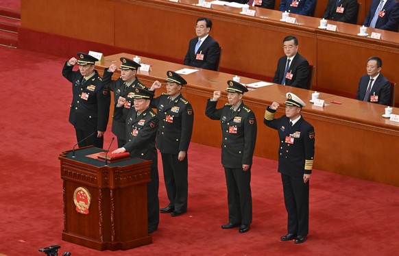 230311 -- BEIJING, March 11, 2023 -- Vice chairmen and members of the Central Military Commission CMC of the People s Republic of China PRC pledge allegiance to the Constitution at the Great Hall of t ...