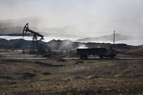 DEREK, SYRIA - NOVEMBER 14: A truck prepares to dump the dregs of oil refined into diesel fuel on November 14, 2015 near Derek, in Rojava, Syria. The predominantly Kurdish autonomous Rojava region of  ...