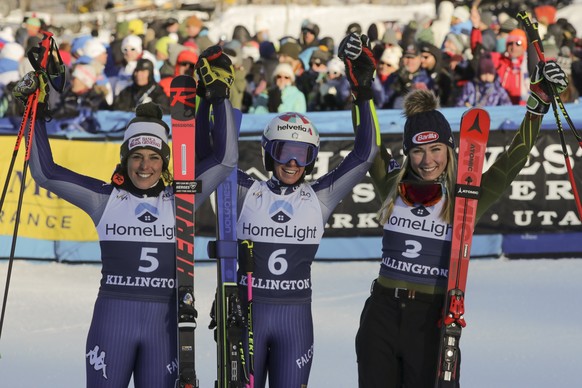 Italy's Marta Bassino, center, winner of an alpine ski, women's World Cup giant slalom, poses with second placed Italy's Federica Brignone, left, and third placed United States' Mi ...
