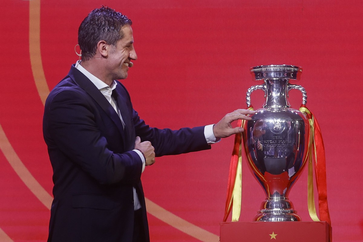 epa11373214 Former Spanish international and UEFA EURO 2008 champion Joan Capdevila touches the Henri Delaunay Trophy during an event where the head coach of the Spanish national soccer team announced ...
