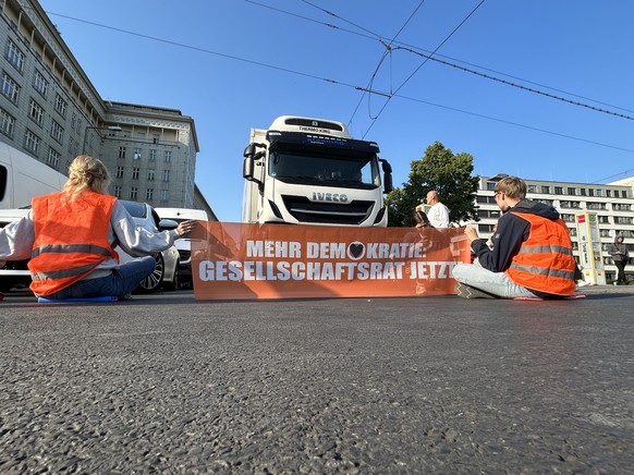 05.06.2023, Berlin: Aktivisten der Gruppe Letzte Generation blockien eine Stra�e. 15 Menschen beteiligten sich laut Polizei an der Aktion im Stadtteil Friedrichshain am Montagmorgen, ein Teil davon kl ...
