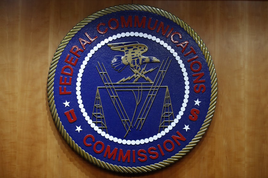 FILE - In this Dec. 14, 2017, file photo, the seal of the Federal Communications Commission (FCC) is seen before an FCC meeting to vote on net neutrality in Washington. The Senate has narrowly approve ...