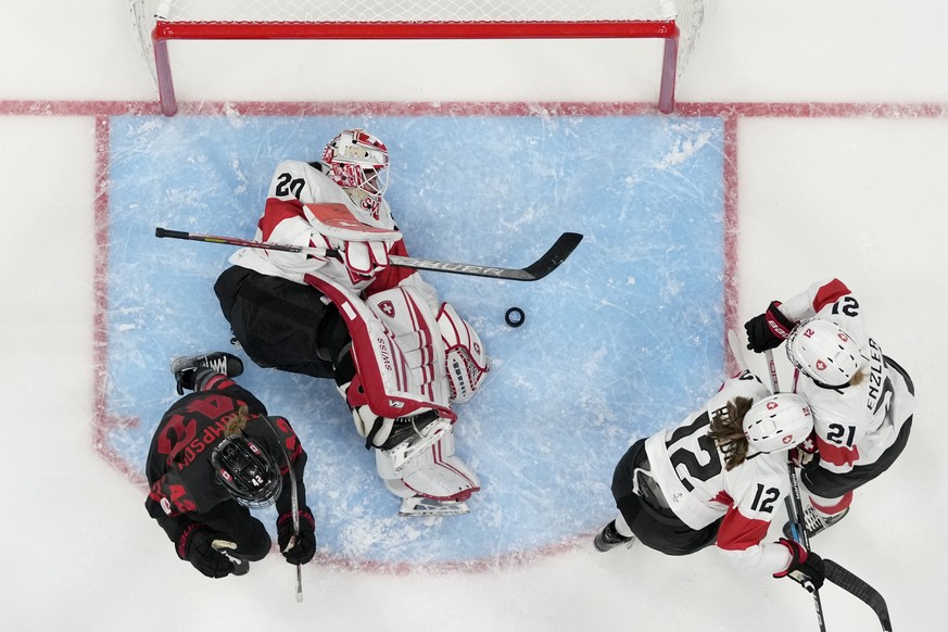 Switzerland goalkeeper Andrea Braendli (20) lies on the ice after giving up a goal against Canada during a preliminary round women&#039;s hockey game at the 2022 Winter Olympics, Thursday, Feb. 3, 202 ...