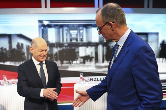 epa11908224 ATTENTION EDITORS - EMBARGOED FOR PUBLICATION UNTIL 19 FEBRUARY 2025 AT 20:15 CET ..German Chancellor Olaf Scholz (L) of the Social Democratic Party (SPD) shakes hands with his conservativ ...