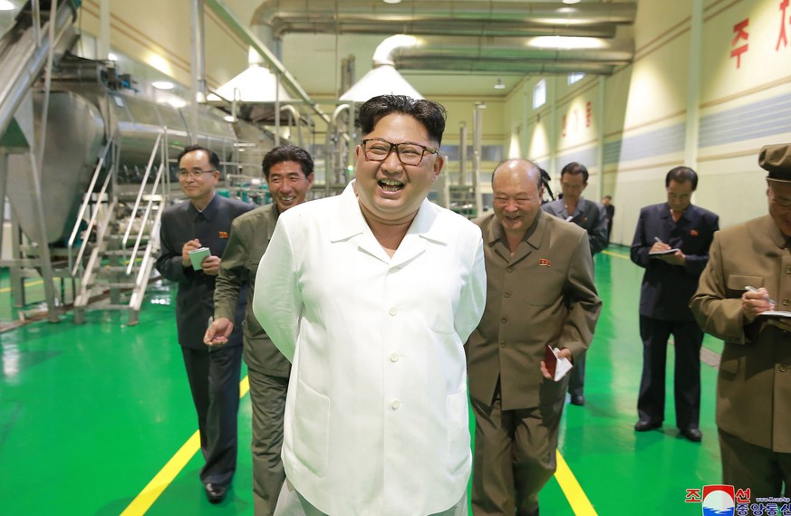 In this undated photo from July 10, 2018, by the North Korean government, North Korean leader Kim Jong Un, center, visits a potato flour production plant in Samjiyon County, North Korea.  ind...