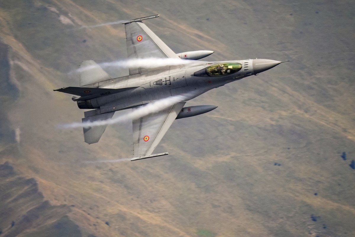 An F-16 Falcon Romanian aircraft flies by during a show of military and acrobatic aviation near the Heroes Cross on Caraiman Peak on top of Bucegi mountains, in Busteni, Romania, Tuesday, Aug. 26, 202 ...