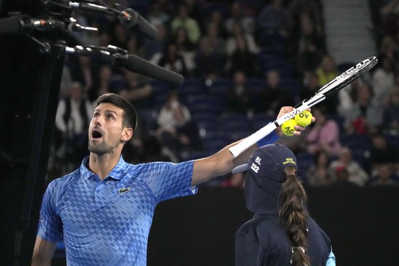 Novak Djokovic of Serbia argues with the chair umpire during his second round match against Enzo Couacaud of France at the Australian Open tennis championship in Melbourne, Australia, Thursday, Jan. 1 ...