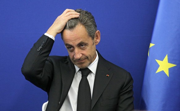 Former French President Nicolas Sarkozy touches his head during the inauguration of the Foundation Claude Pompidou, Centre teaching and research on Alzheimer&#039;s disease, Monday, March 10, 2014. in ...