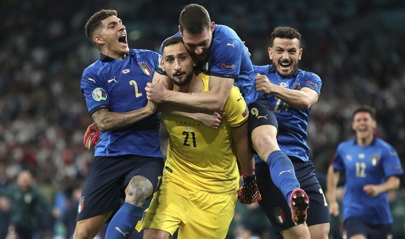 Italy players celebrate with goalkeeper Gianluigi Donnarumma after he saved the last penalty shot of the Euro 2020 soccer championship final match between England and Italy at Wembley Stadium in Londo ...