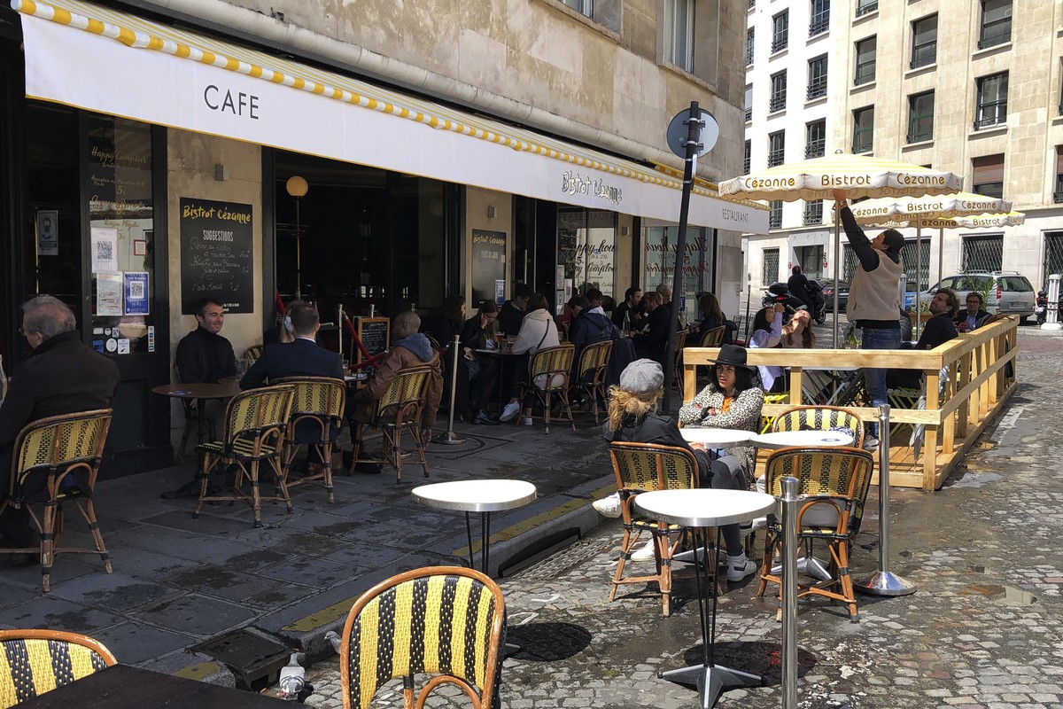 Customers sit at a restaurant terrace in Paris, Wednesday, May, 19, 2021. Cafe and restaurant terraces reopened Wednesday after a six-month coronavirus shutdown deprived residents of the essence of Fr ...