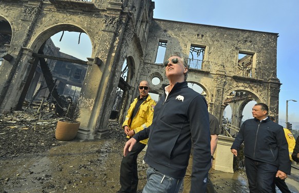 California Governor Gavin Newsom, center, surveys damage in Pacific Palisades with CalFire&#039;s Nick Schuler, left, and Senator Alex Padilla, D-Calif., during the Palisades Fire Wednesday, Jan. 8, 2 ...