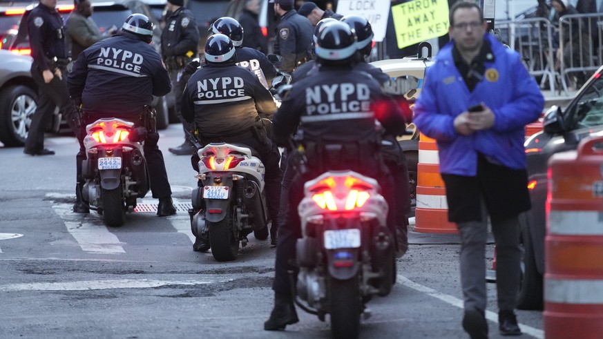 New York City police officers on scooters line up outside Manhattan criminal courts building, Thursday, March 30, 2023, in New York. (AP Photo/Mary Altaffer)